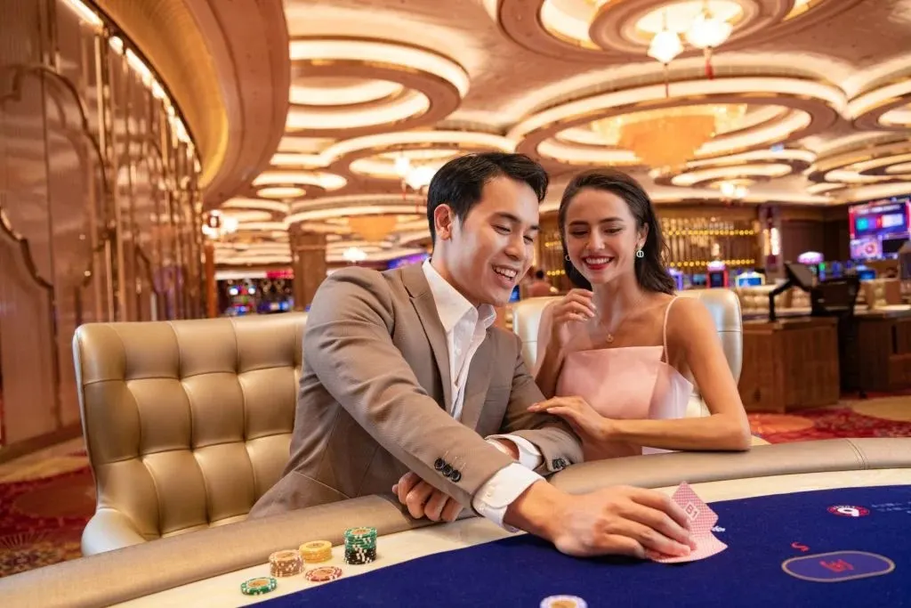 Image of a Sicbo casino in Vietnam, featuring a modern casino building with vibrant lighting, dedicated Sicbo gaming tables, and patrons actively playing the dice game in a lively and upscale casino setting.