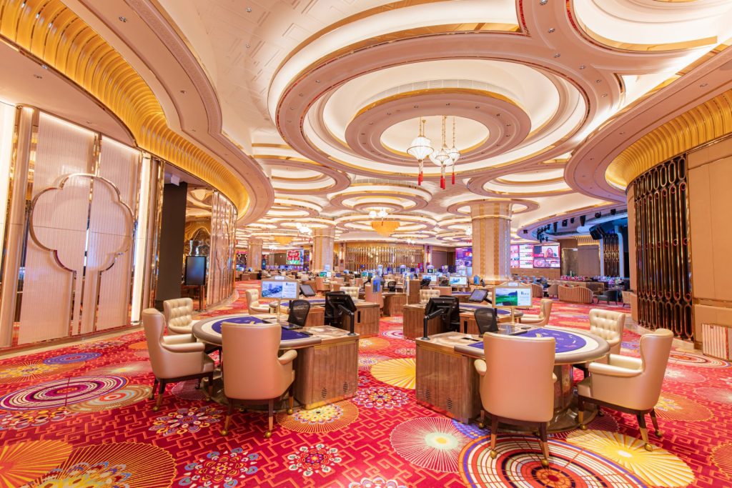 Elegant casino floor with tables and slot machines at Hoiana Resort