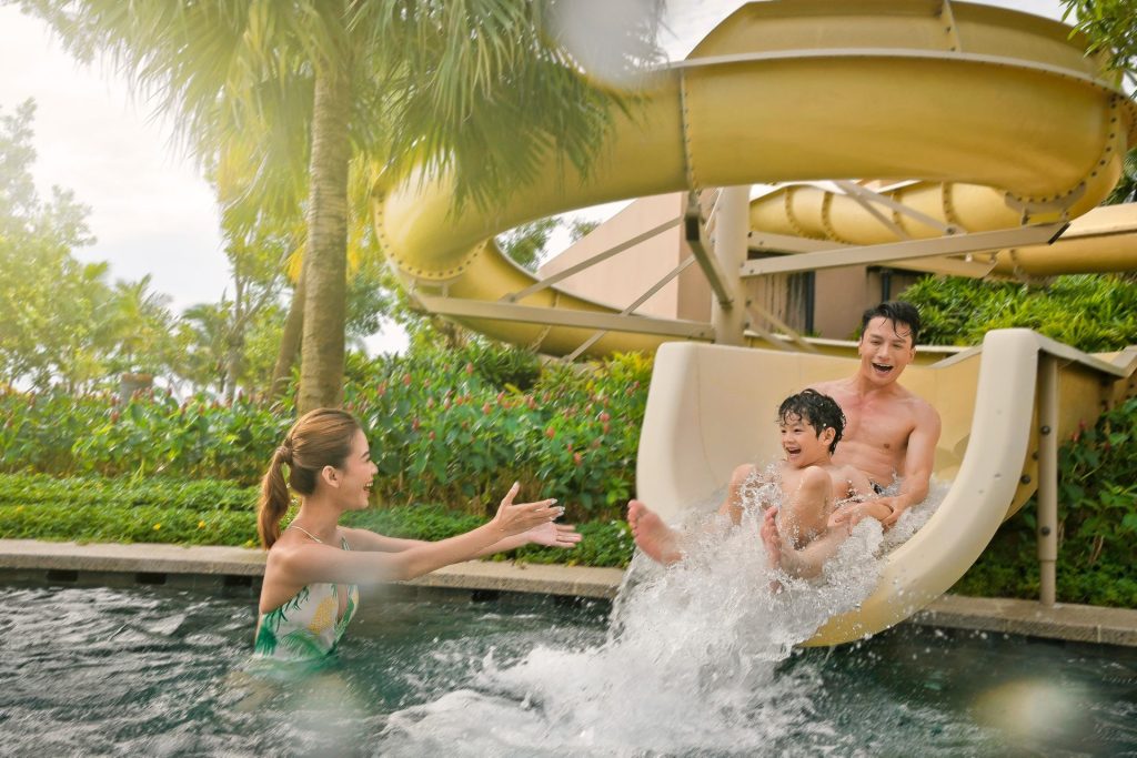 Family enjoying water activities at a resort pool