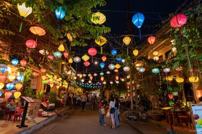 Hoi An nightlife with colorful lanterns lighting up the streets and lively riverside cafes