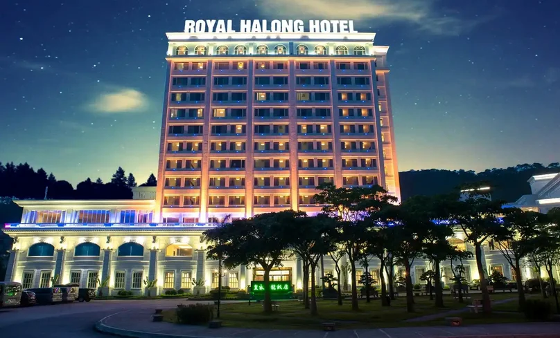 Illuminated Casino Royal with limestone karsts of Halong Bay visible Caption