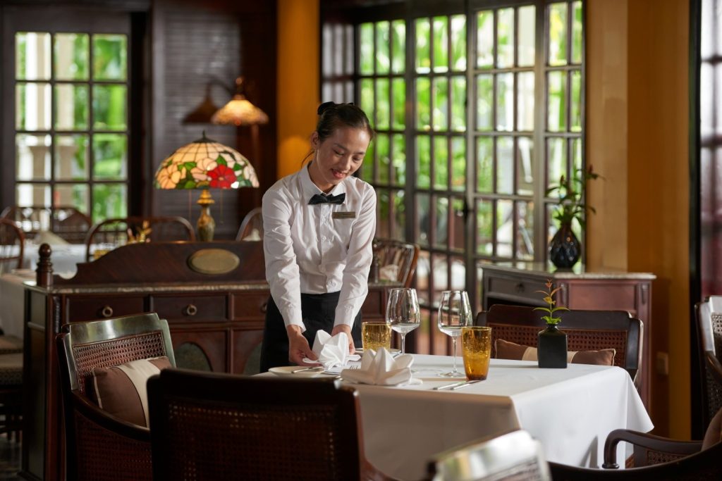 Exterior view of The Temple Restaurant in Hoi An, with its grand entrance and lush garden setting.