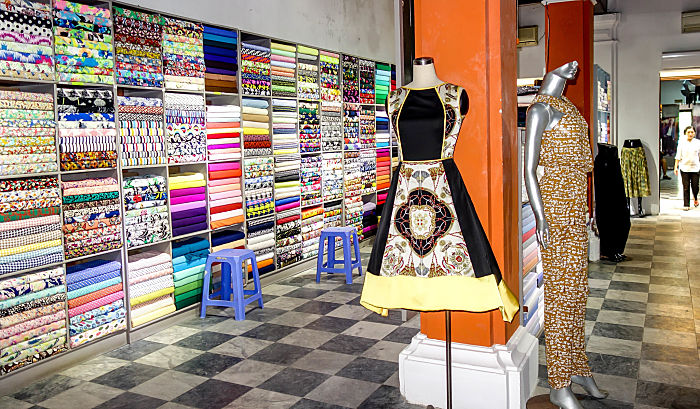 Interior of Yaly Couture & Custom Tailor in Hoi An, showcasing a luxurious space filled with elegant fabrics and designs