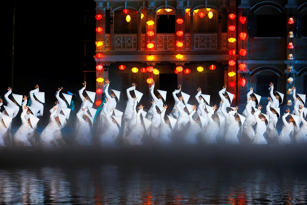 Performers wearing traditional Ao Dai during the Hoi An Memories Show, highlighting the elegance and cultural significance of this Vietnamese garment.