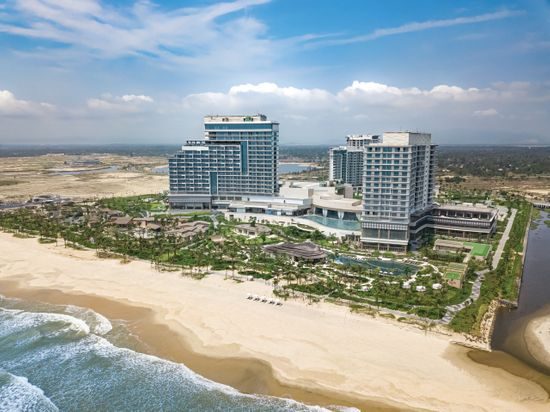 Aerial view of Hoiana Resort & Golf, showcasing its expansive golf course, luxurious accommodations, and beachside location