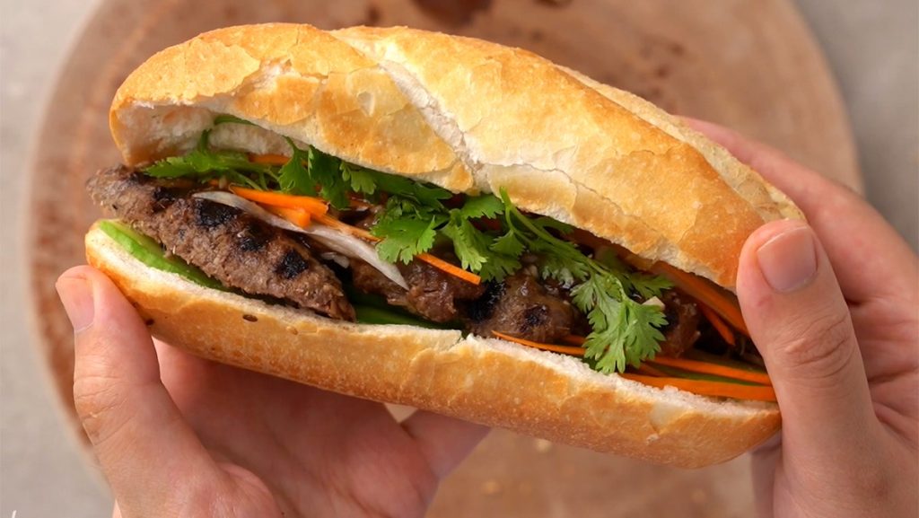  Banh mi sandwich filled with pork, vegetables, and herbs