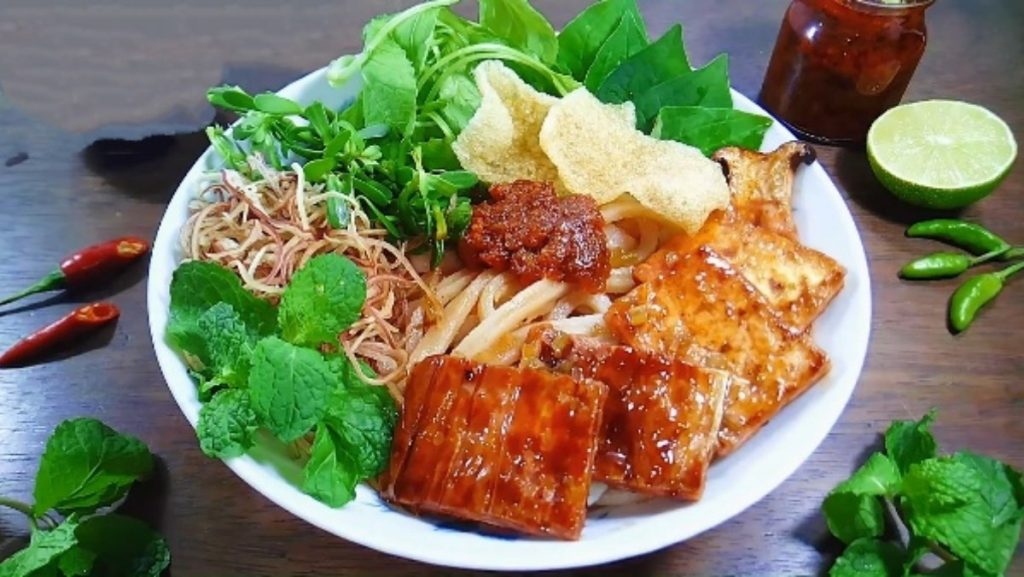 Traditional bun cha spread with grilled pork, noodles, and dipping sauce