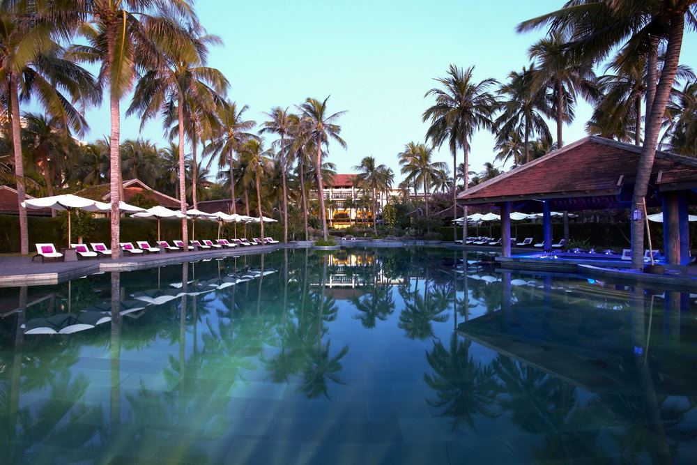 A beachfront wedding ceremony at Anantara Mui Ne Resort with palm trees and white sand.