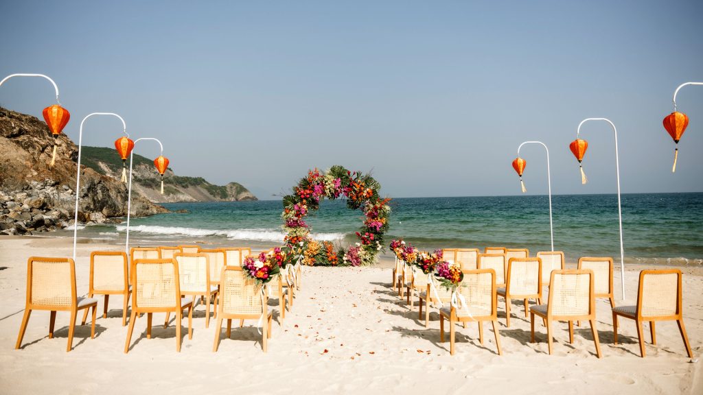 A secluded beach wedding venue at Mia Resort Nha Trang, overlooking clear blue waters.