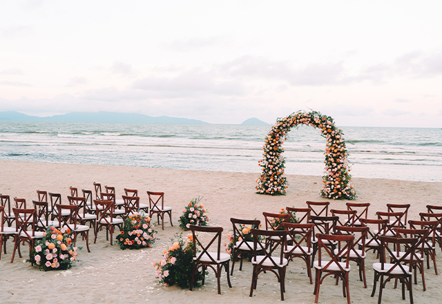 A stunning beachside wedding venue with elegant décor and the ocean as a backdrop.