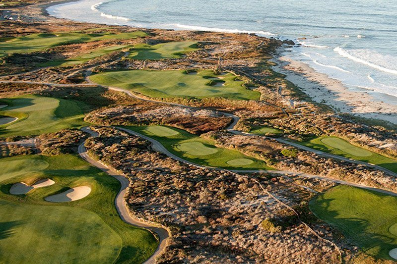 A panoramic view of Hoiana Golf Course, showcasing its vast fairways and coastal landscape.