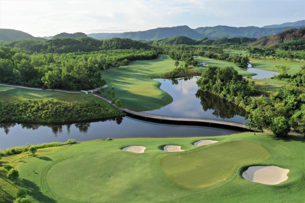 Ba Na Hills Golf Club with its rolling hills and a golfer teeing off on the scenic course.