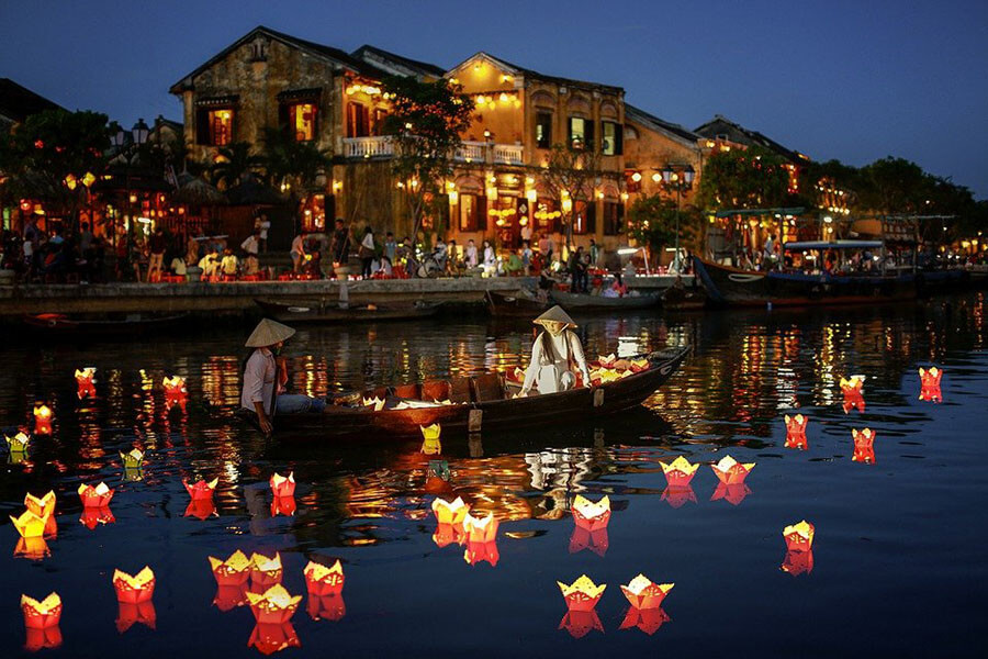 Tourists releasing lanterns onto the Hoai River during the Hoi An Lantern Festival.