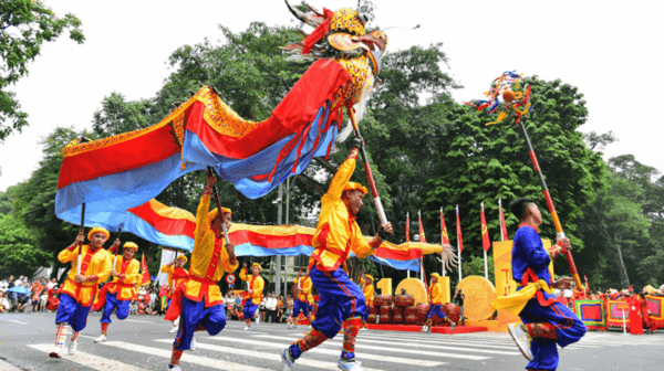 Performers in vibrant costumes executing a traditional Vietnamese dragon dance.