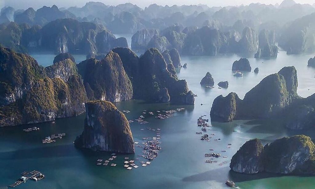 Limestone karsts rising out of the emerald waters of Ha Long Bay.