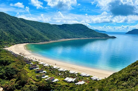 A private beach at Six Senses Con Dao with secluded villas surrounded by nature.