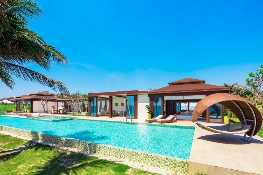 A villa with a private pool at Fusion Resort Cam Ranh, surrounded by nature.