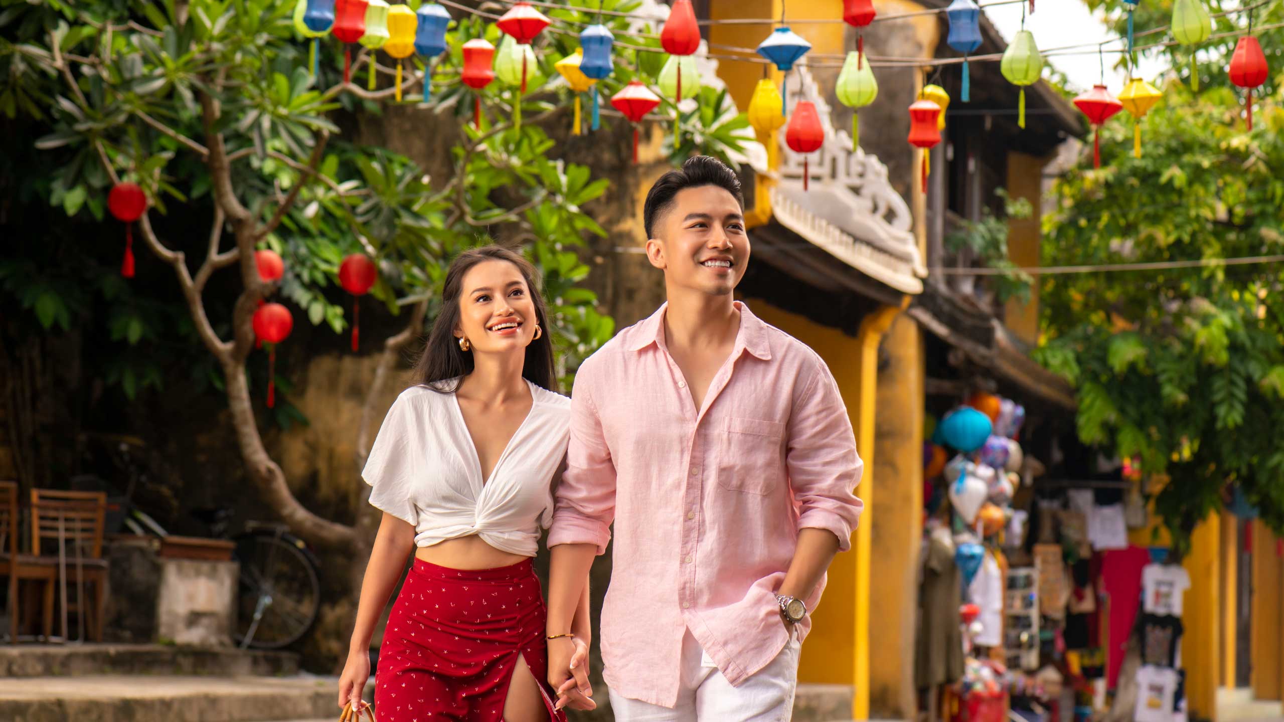 A couple relaxing by the pool at a romantic resort in Vietnam.