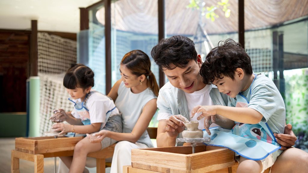 A happy family relaxing at a beachside resort, children playing while parents unwind