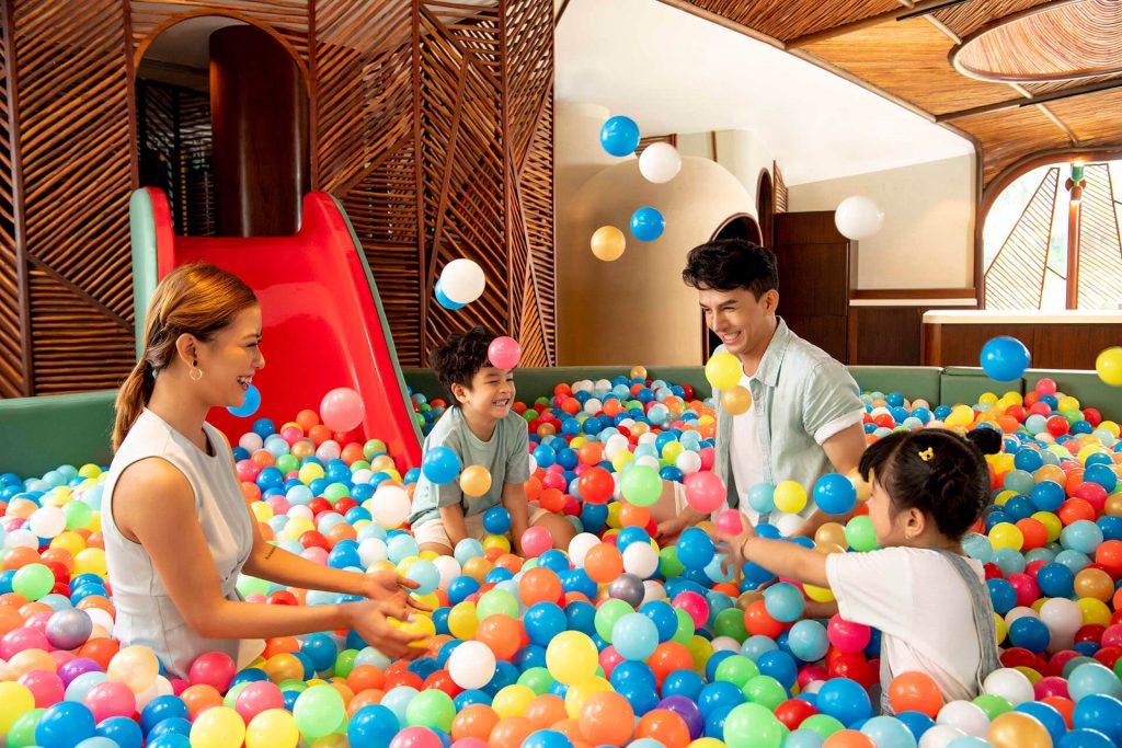 A kid's club at a resort with children participating in fun activities under supervision.