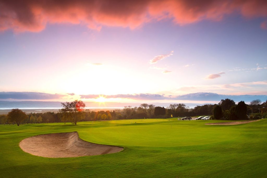  A nearly empty golf course at twilight, providing ample space and freedom to play.