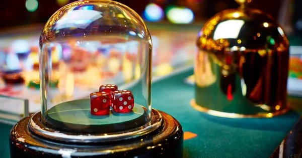 Overview of Sicbo, a traditional dice game played in casinos, featuring players seated around a gaming table with multiple dice, betting chips on the table, and a dealer preparing to roll the dice, highlighting the game's vibrant and engaging atmosphere.