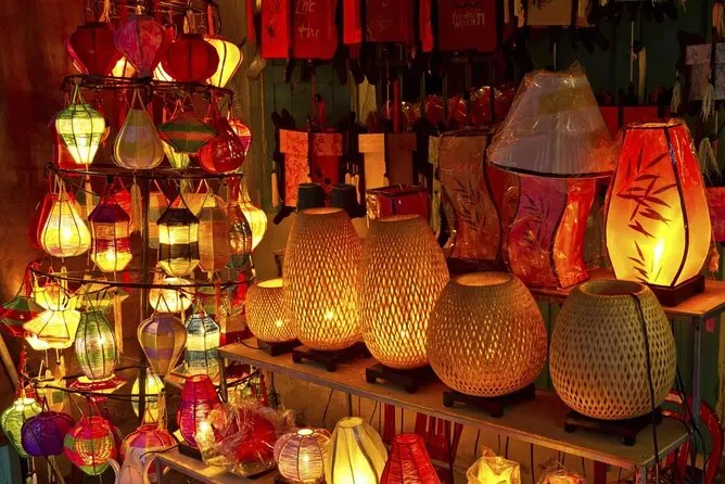 A bustling scene at Hoi An Market with vendors selling traditional Vietnamese foods, souvenirs, and handmade goods.