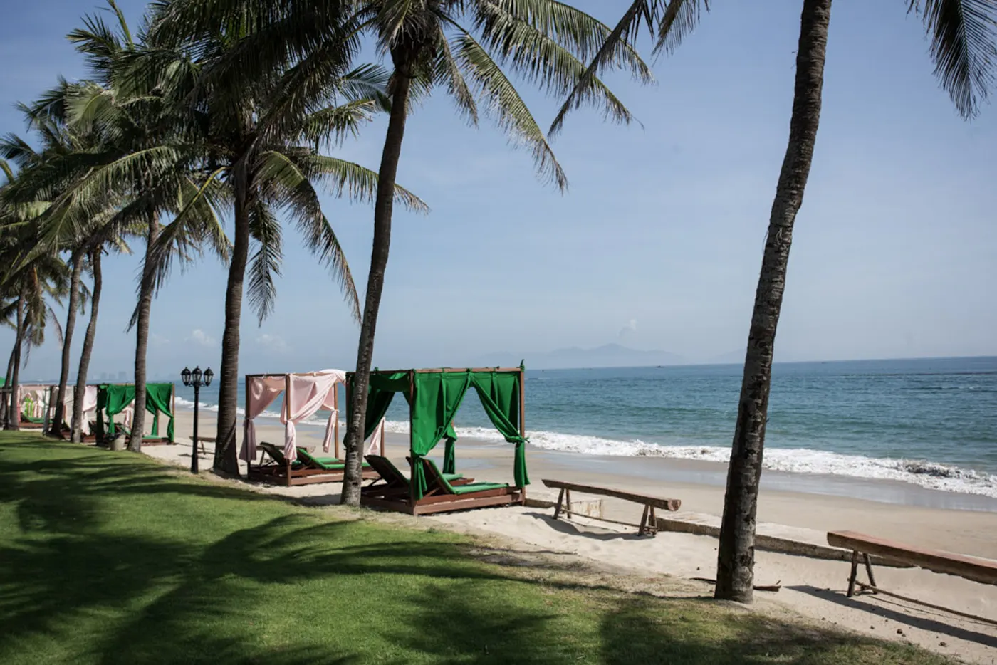 A serene sunset over the best beach in Hoi An, with gentle waves lapping at the shore and vibrant skies, making it a must-visit destination in Hoi An.