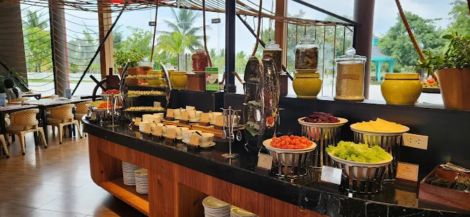 Traditional Vietnamese breakfast spread in Hoi An, featuring a variety of fresh ingredients like pho, banh mi, tropical fruits, and herbal teas, served in a charming local restaurant.