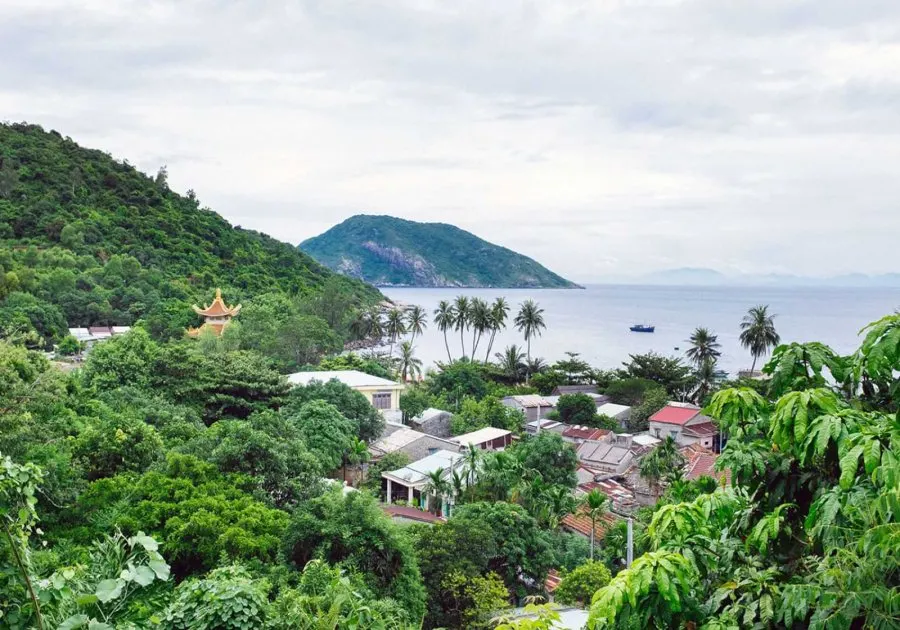 Scenic view of Cham Island, Hoi An, featuring lush greenery, crystal-clear waters, and a tranquil atmosphere perfect for relaxation and exploration.