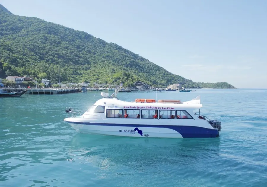 Scenic view of Cham Island, Hoi An, featuring lush greenery, crystal-clear waters, and a tranquil atmosphere perfect for relaxation and exploration.