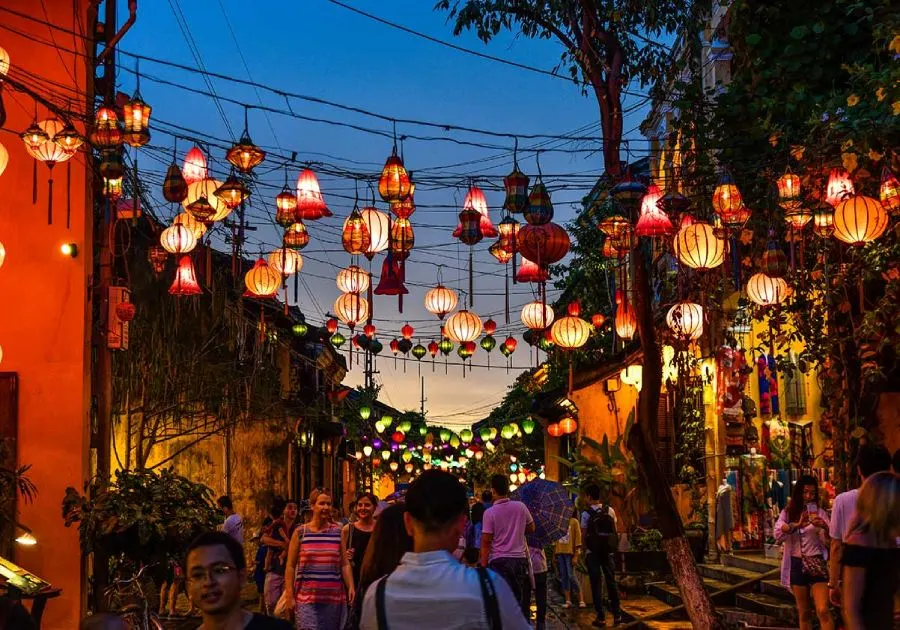 Shimmering lanterns illuminate the bustling Hoi An Night Market, offering visitors a mix of handmade goods and delicious Vietnamese delicacies.