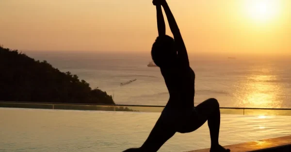 Serene yoga practice in a lush garden setting in Hoi An, surrounded by tropical greenery and a tranquil atmosphere.