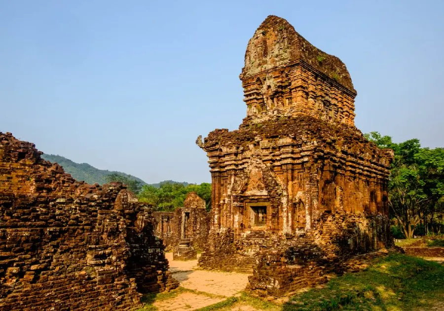 The ancient My Son Sanctuary, a UNESCO World Heritage site in Vietnam, showcasing intricate Hindu temple ruins surrounded by lush greenery.