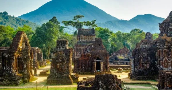 The ancient My Son Sanctuary, a UNESCO World Heritage site in Vietnam, showcasing intricate Hindu temple ruins surrounded by lush greenery.