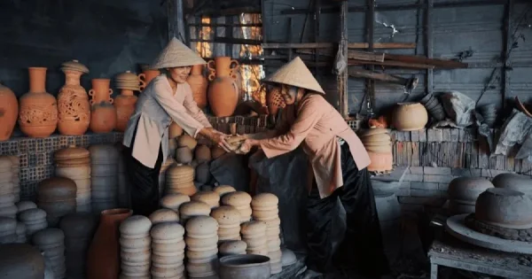 A view of Thanh Ha Pottery Village in Hoi An, showcasing traditional pottery artisans crafting unique ceramic pieces with vibrant colors and intricate designs.