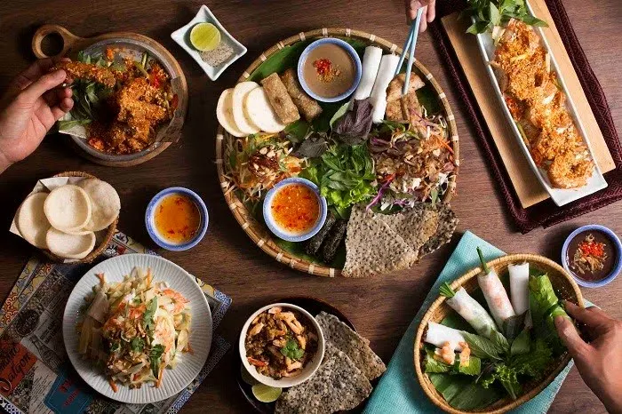 호이안 깜남섬: 호이안 깜남섬의 평화로운 풍경, 푸른 강물과 전통 배가 어우러진 아름다운 자연 경관.
