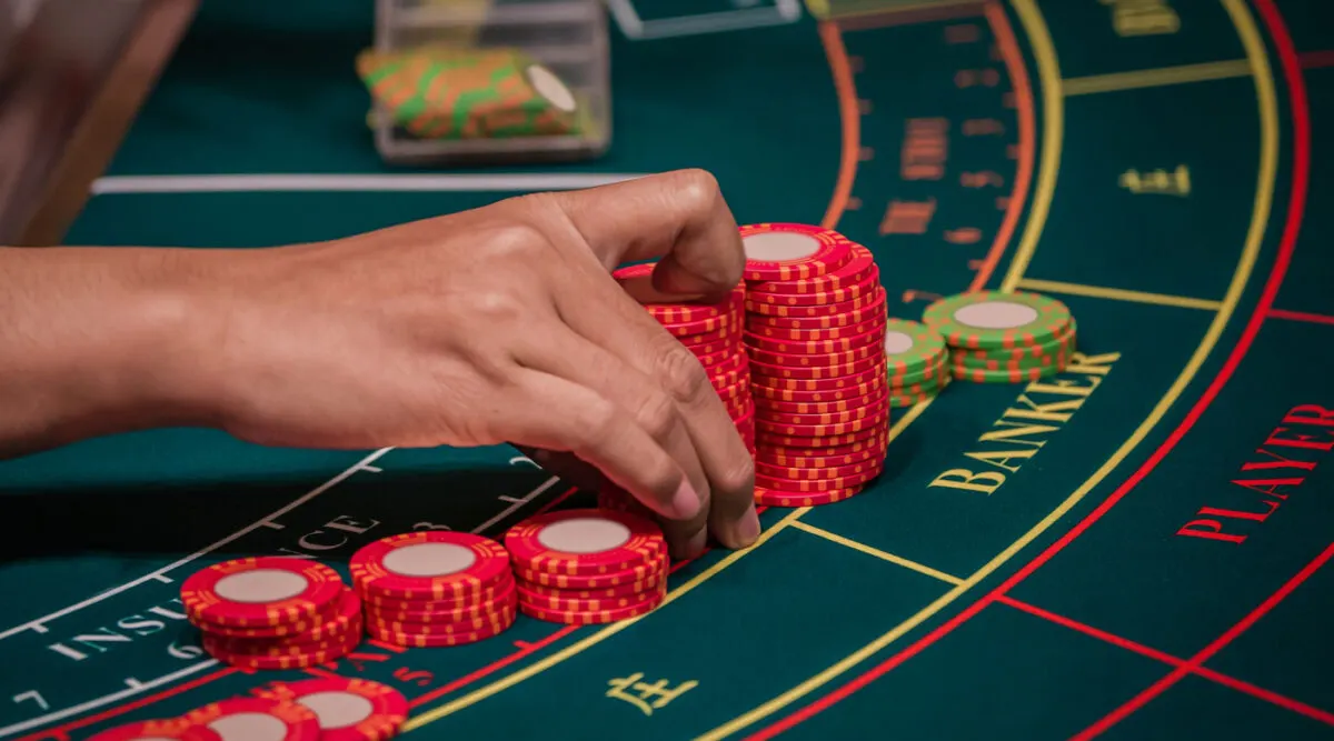 People enjoying various Table Games in Vietnam at a lively casino, with cards and chips on the table.
