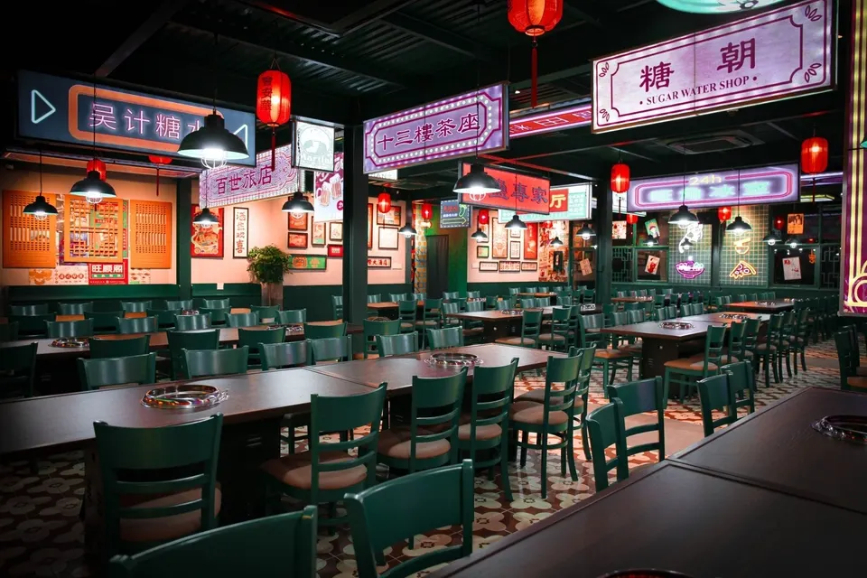 "Traditional Chinese restaurant in Hoi An with classic red lantern decor, round dining tables, and a menu featuring dim sum, Peking duck, and regional specialties."