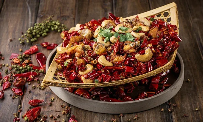 "Traditional Chinese restaurant in Hoi An with classic red lantern decor, round dining tables, and a menu featuring dim sum, Peking duck, and regional specialties."