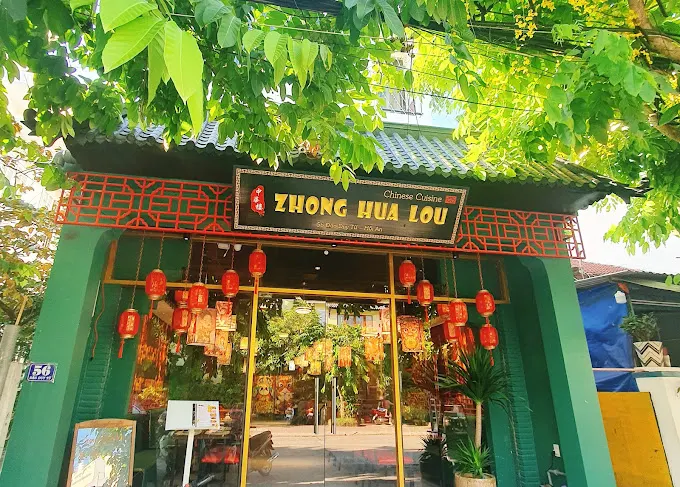 "Traditional Chinese restaurant in Hoi An with classic red lantern decor, round dining tables, and a menu featuring dim sum, Peking duck, and regional specialties."