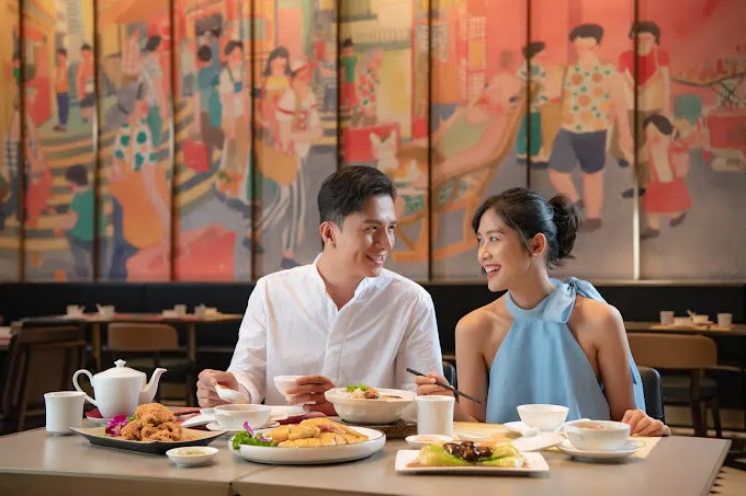 "Traditional Chinese restaurant in Hoi An with classic red lantern decor, round dining tables, and a menu featuring dim sum, Peking duck, and regional specialties."