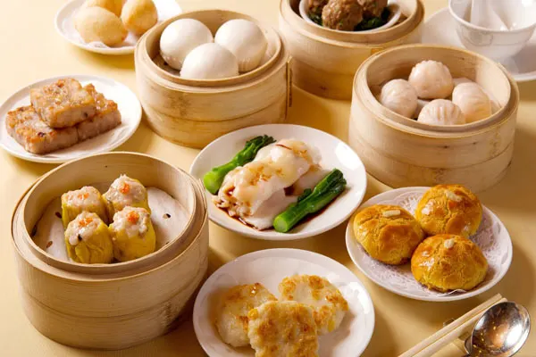 "Traditional Chinese restaurant in Hoi An with classic red lantern decor, round dining tables, and a menu featuring dim sum, Peking duck, and regional specialties."