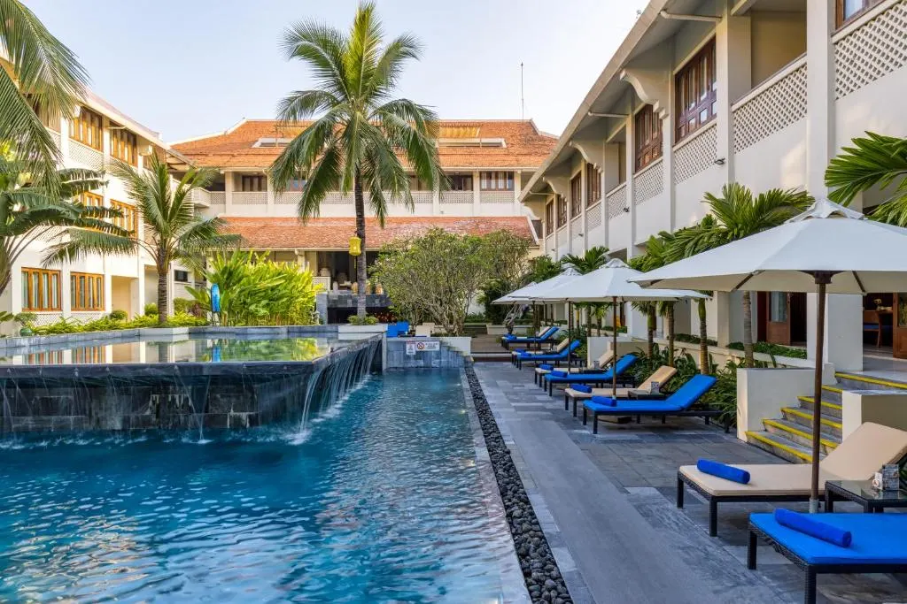Khung cảnh thư giãn tại resort có bể bơi vô cực tại Hội An, với tầm nhìn hướng ra thiên nhiên yên bình và thiết kế sang trọng giữa không gian mở.